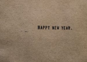 a piece of brown paper with the words happy new year written on it